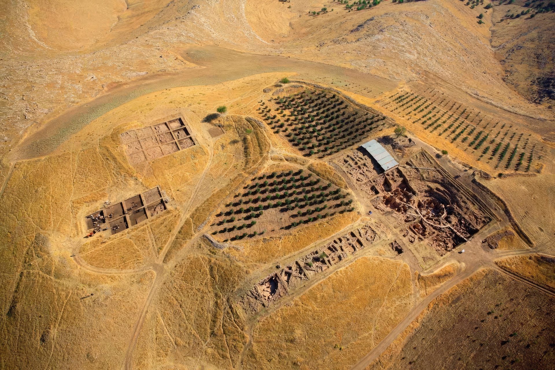 A photograph of the remains of ancient structures on top of a hill at Gobekli Tepe, Turkey.
