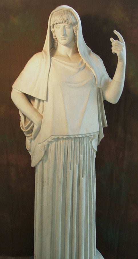 A sculpture of Hestia, her head is covered and her left arm is raised