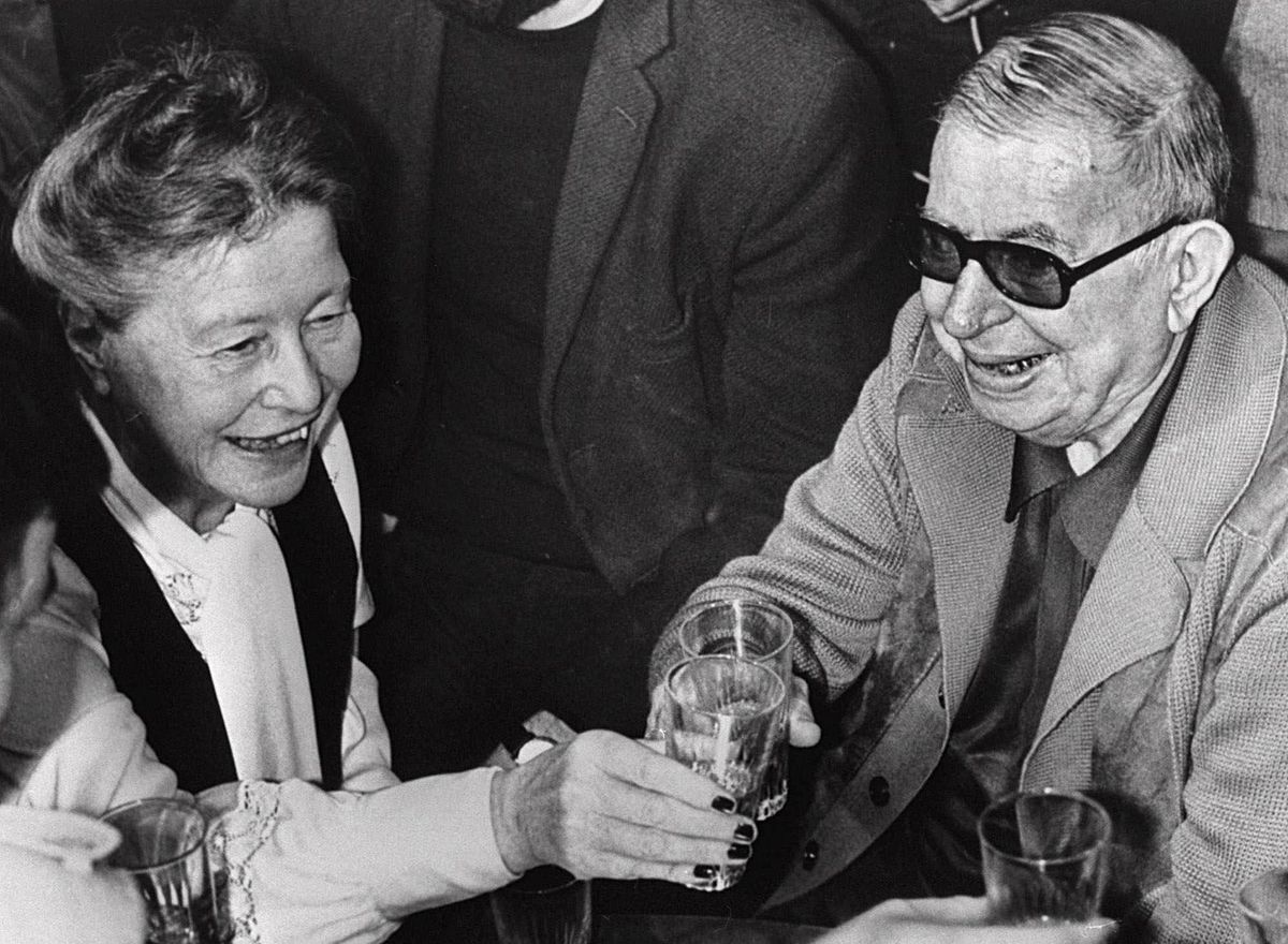 A photograph of Simone de Beauvoir and Jean-Paul Sartre having a drink together.